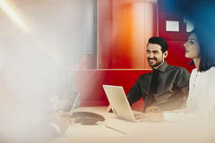 Business man and woman in an office having a meeting