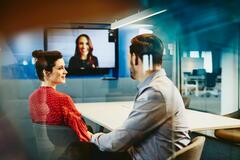 Man and woman in an office having a Hangout