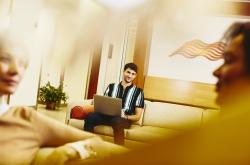 Smiling man is working on his laptop