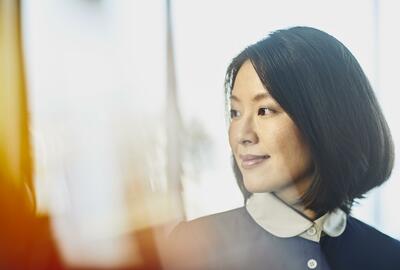 Woman smiling. China. Primary color: yellow.