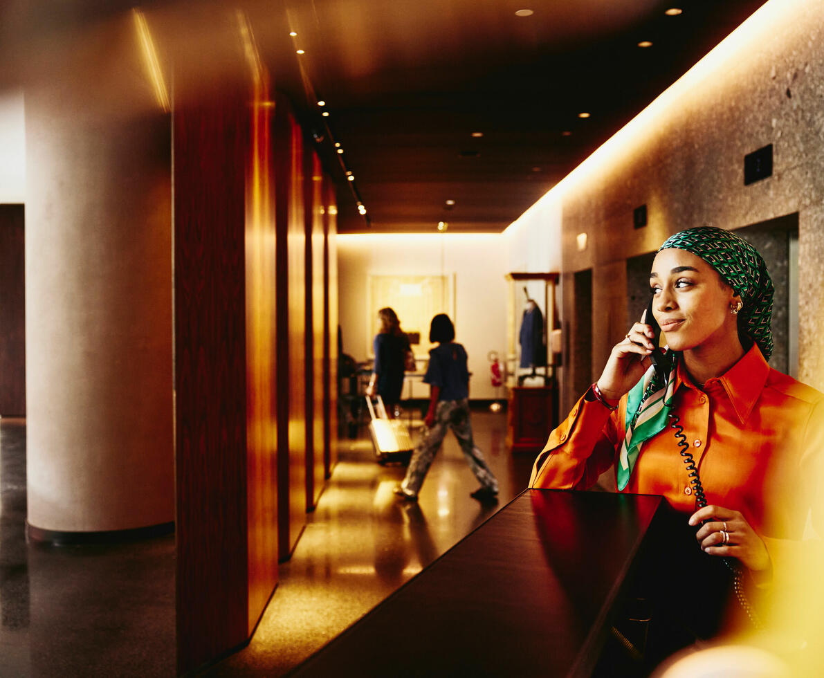 A smiling woman speaking over the phone