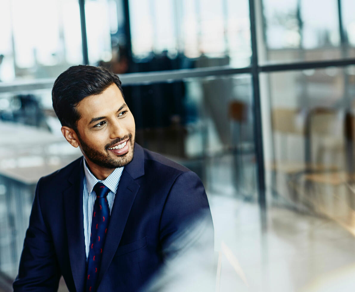 A man in a suit smiling